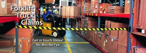An image of a man on a forklift truck taking a pallet from a shelf in a warehouse