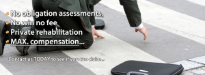 An image of a man on his hands and knees who has fallen over on a zebra crossing. His business cases are scattered around him.