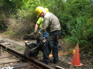 two me working with a railway